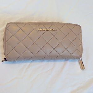 Michael Kors tan quilted leather wallet 8.25” long, 4” tall.